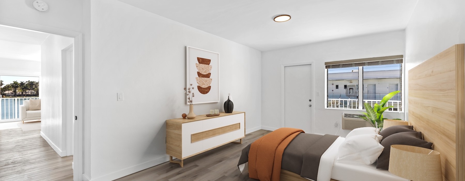 bedroom with bed plant and windows