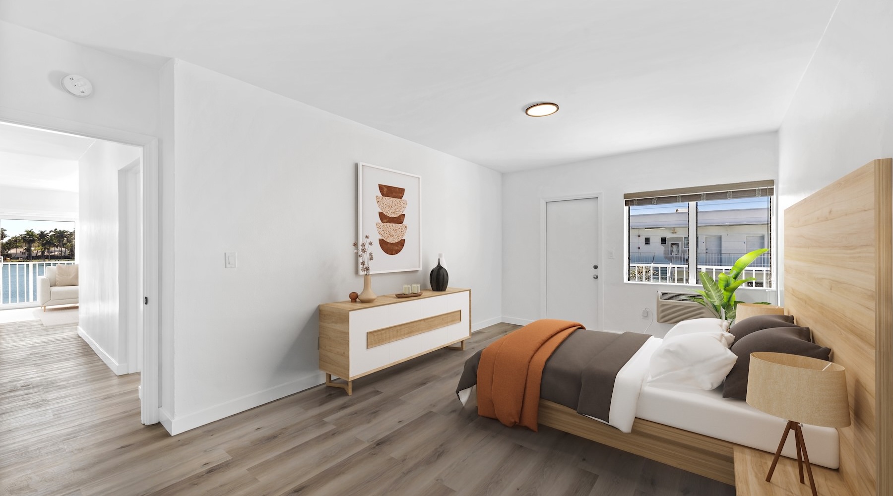 bedroom with bed plant and windows