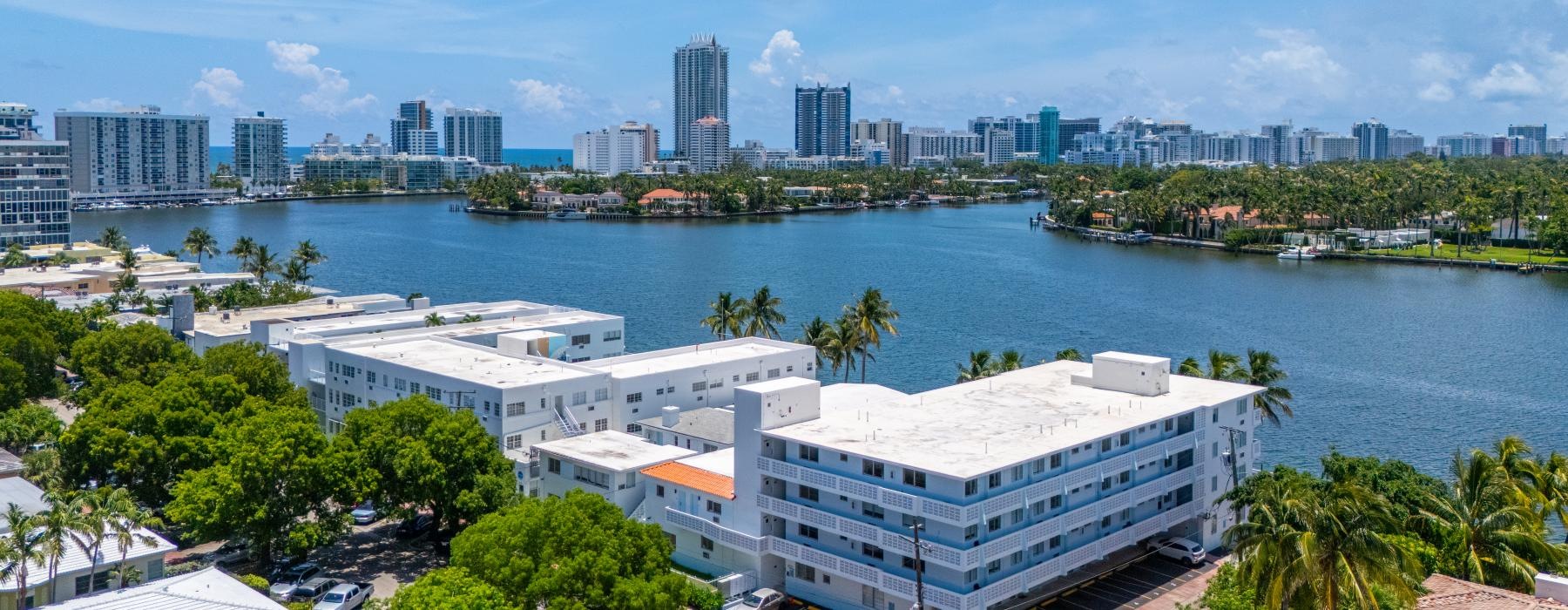 a body of water with buildings and trees around it