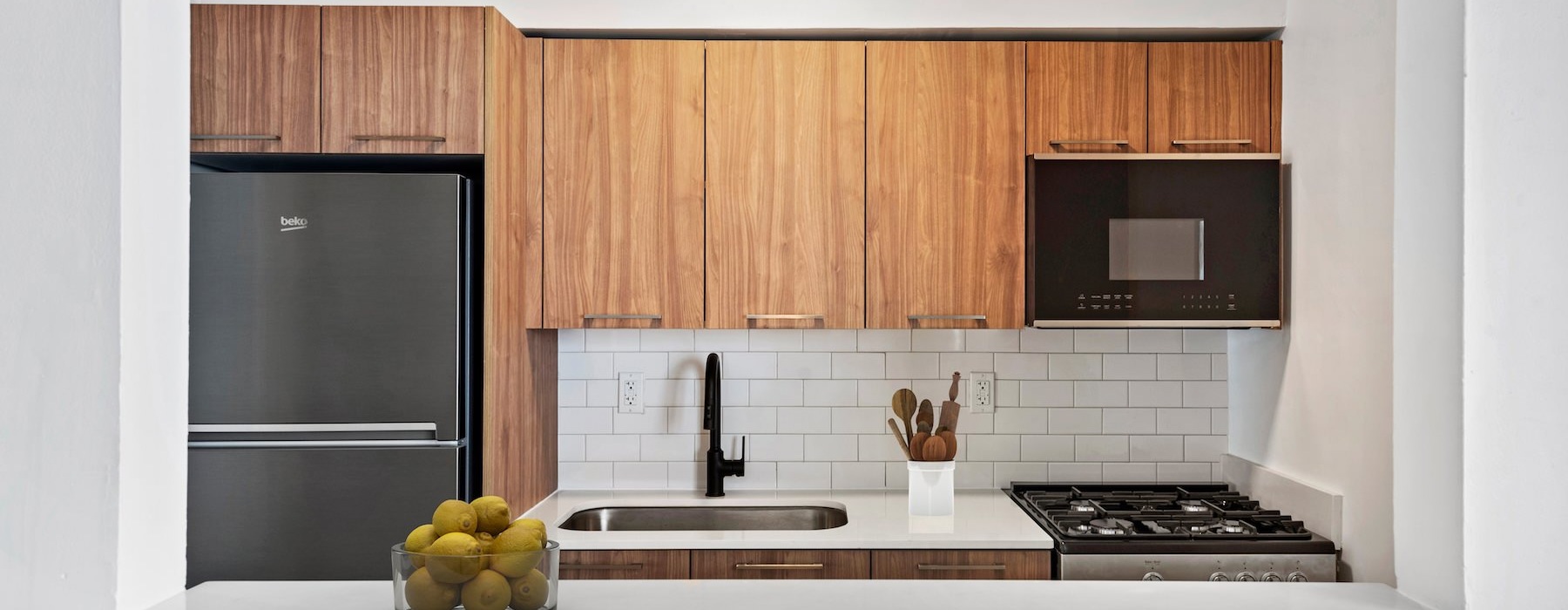 a kitchen with wood cabinets and stainless steel appliances