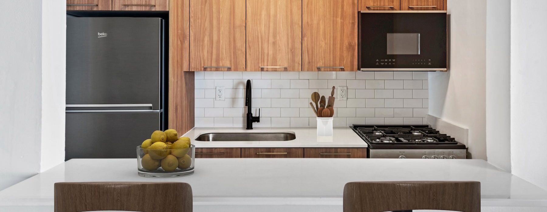a kitchen with wood cabinets and stainless steel appliances