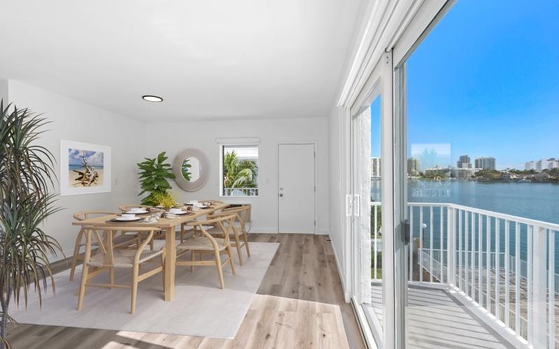 a table chairs and plants in a dining room
