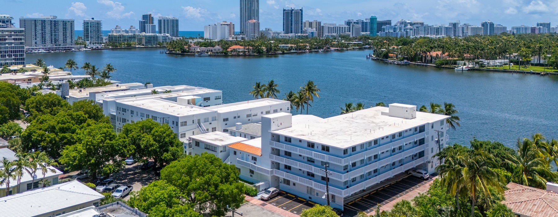 a body of water with buildings and trees around it
