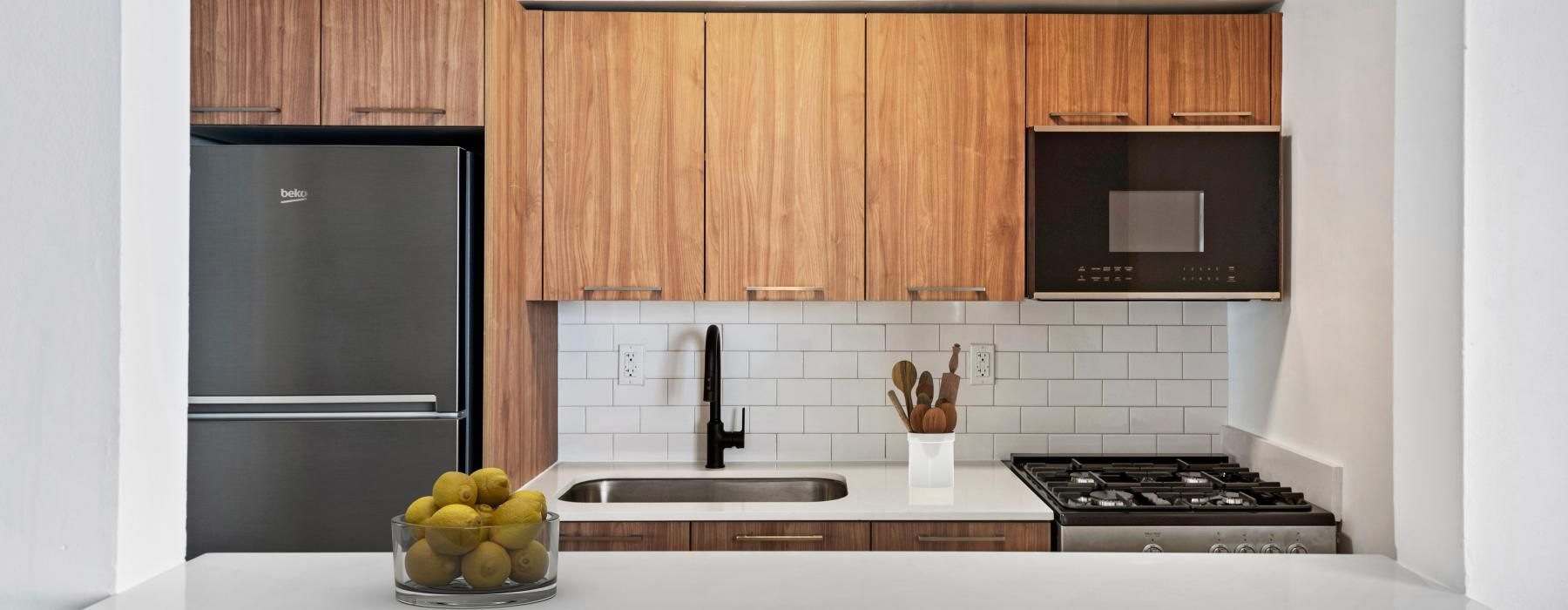 a kitchen with wood cabinets and stainless steel appliances